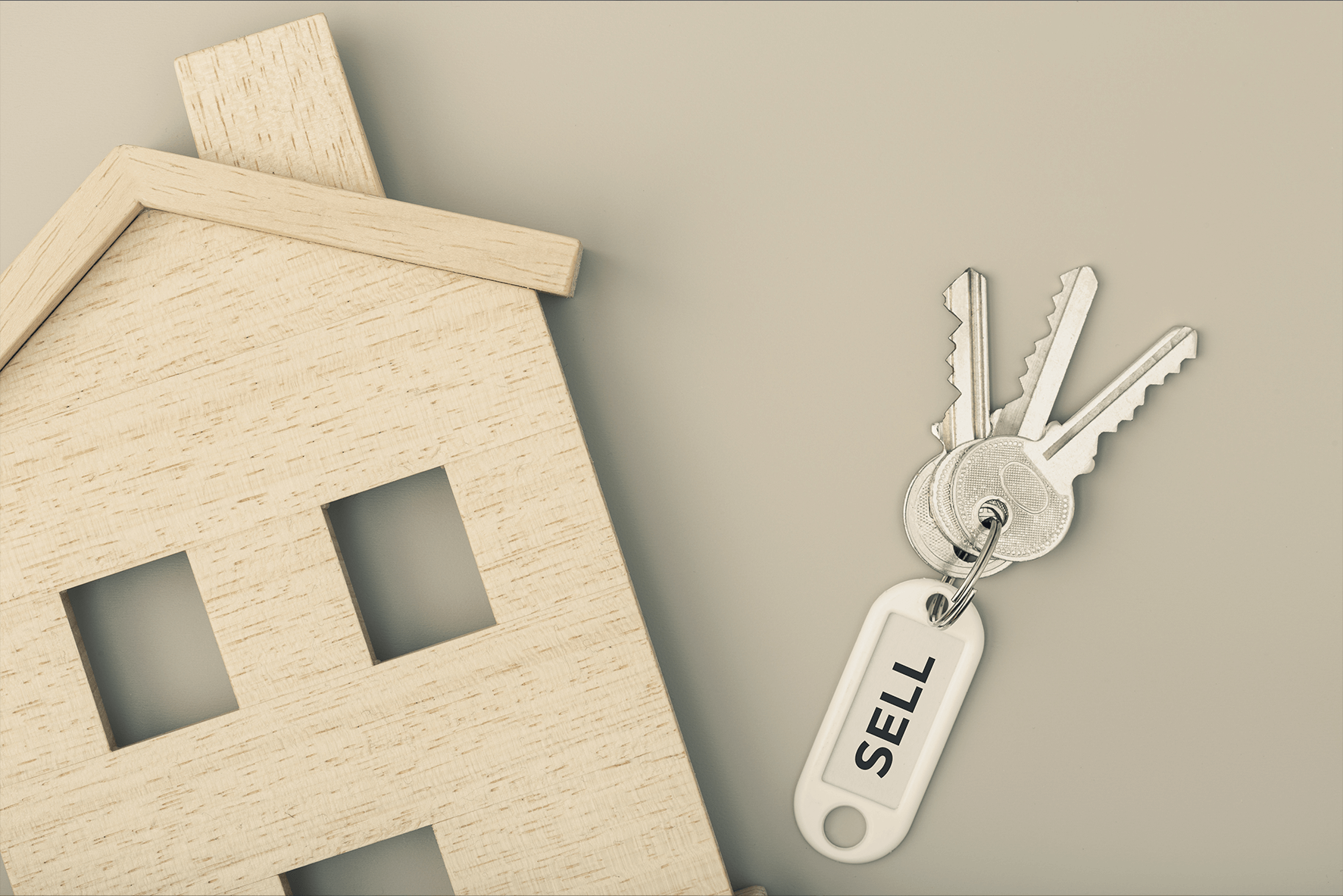 Wooden house on table with keys how long does it take to sell a house (1)